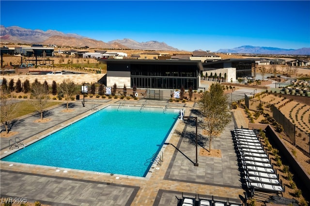 view of pool featuring a mountain view and a patio