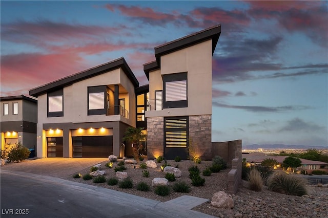 contemporary home with a garage and a balcony