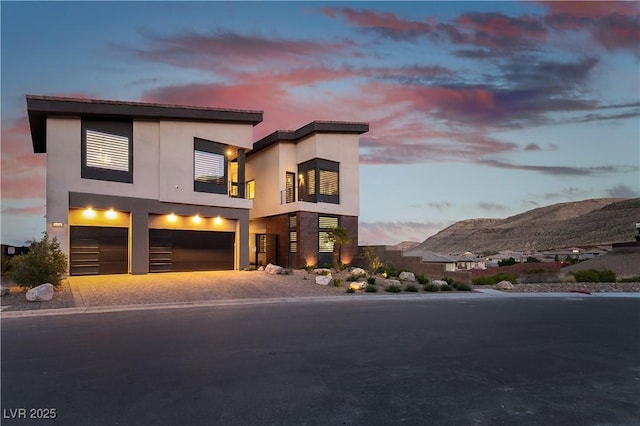 view of front of home featuring a garage and a mountain view