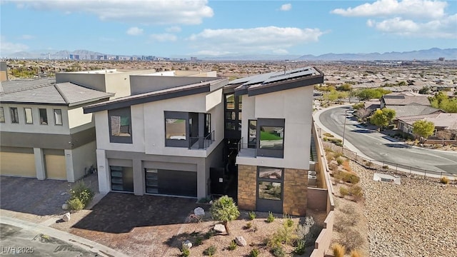 view of front of house with a mountain view and solar panels