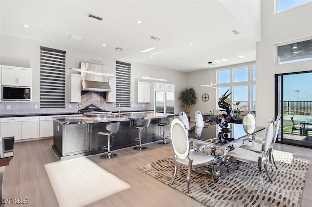 dining space with sink and light wood-type flooring