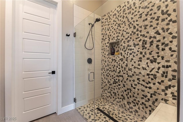 bathroom featuring tile patterned flooring and walk in shower