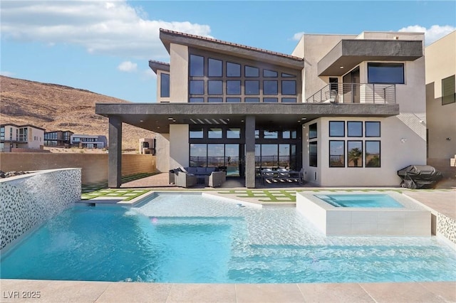 view of pool with an in ground hot tub