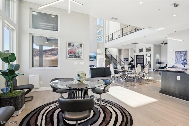 living room featuring a high ceiling and light hardwood / wood-style floors