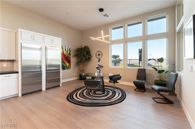 interior space with a chandelier and light wood-type flooring