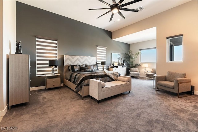 bedroom with ceiling fan and dark carpet