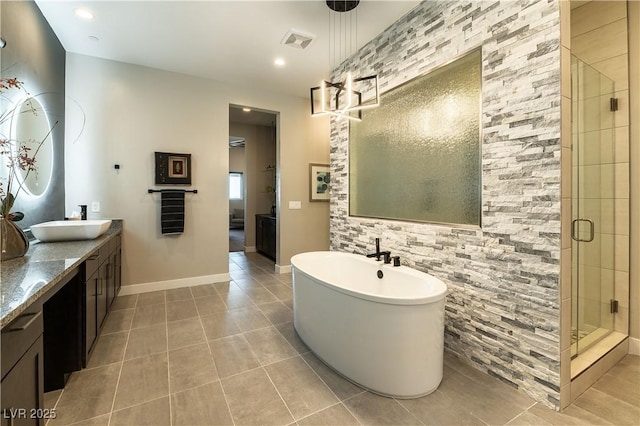 bathroom featuring vanity, shower with separate bathtub, and tile patterned flooring