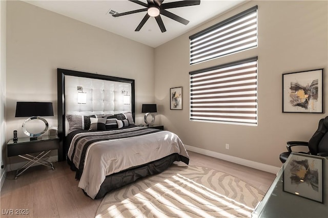 bedroom with light hardwood / wood-style flooring and ceiling fan