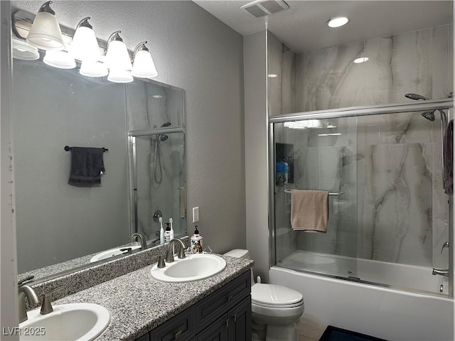 full bathroom with bath / shower combo with glass door, vanity, and toilet