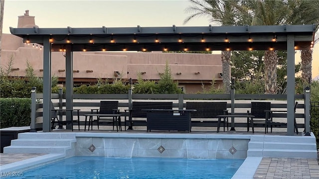 pool at dusk with pool water feature