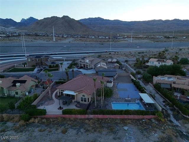 birds eye view of property with a mountain view