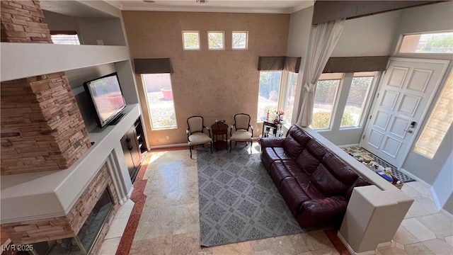 living room with crown molding and a wealth of natural light