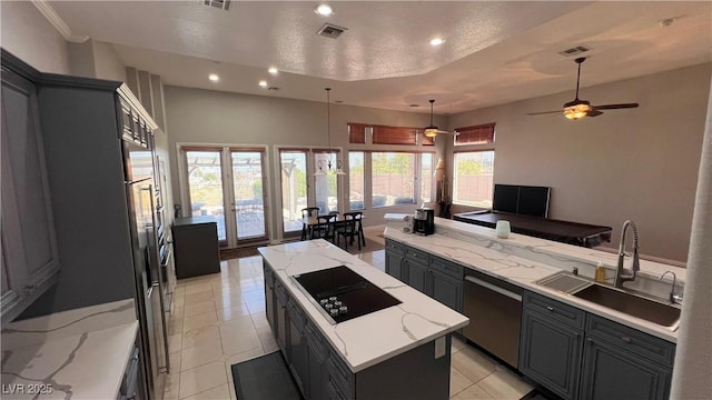 kitchen with sink, a center island, light stone countertops, black electric cooktop, and stainless steel dishwasher