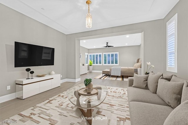 living room with light wood-style flooring, baseboards, ceiling fan, and recessed lighting