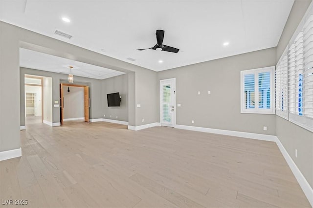 unfurnished living room featuring light wood finished floors, baseboards, visible vents, and a ceiling fan