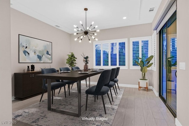 dining space with recessed lighting, visible vents, light wood-style flooring, a chandelier, and baseboards