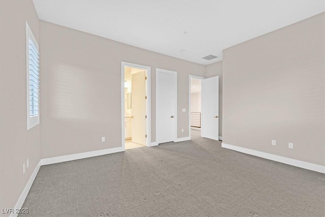 unfurnished bedroom featuring carpet, visible vents, and baseboards