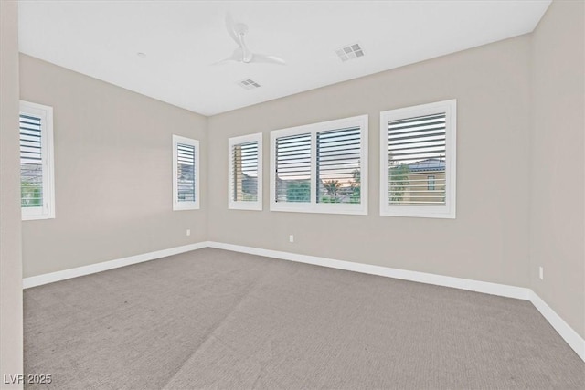 carpeted empty room with baseboards and visible vents