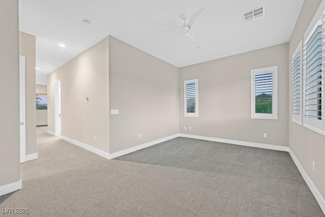 empty room featuring recessed lighting, carpet, visible vents, and baseboards