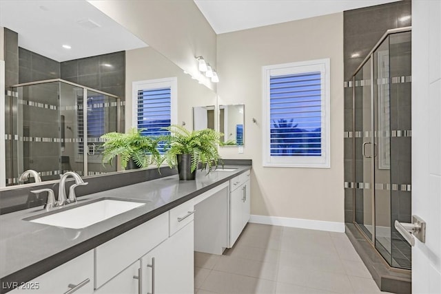 bathroom with double vanity, tile patterned flooring, a sink, and a shower stall