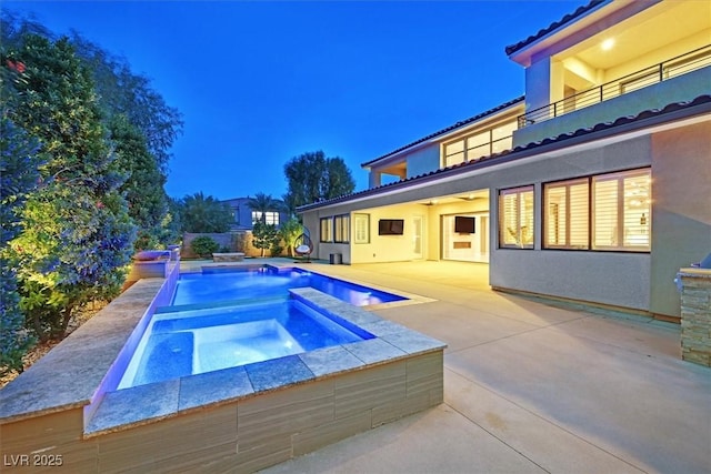 view of swimming pool with an in ground hot tub, a patio area, and a fenced in pool