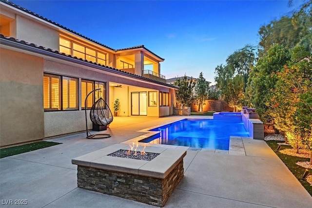 view of pool with a fire pit, a fenced in pool, and a patio