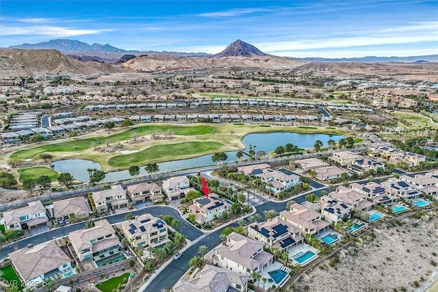 drone / aerial view with a residential view, golf course view, and a water and mountain view