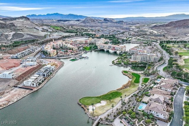 drone / aerial view featuring a water and mountain view