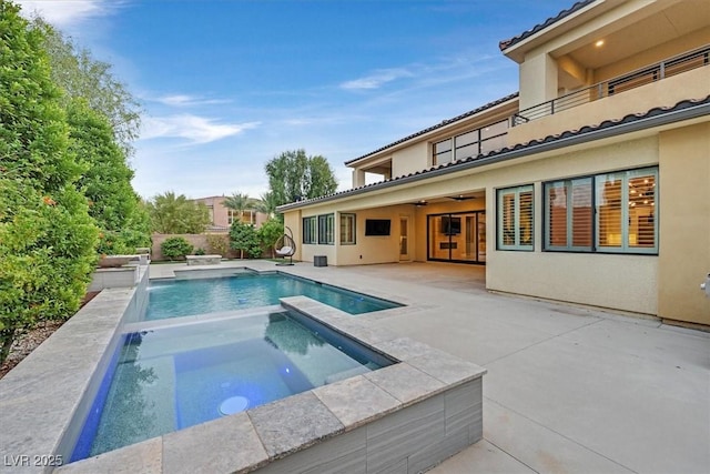 view of pool with a patio area, a fenced in pool, a ceiling fan, and an in ground hot tub