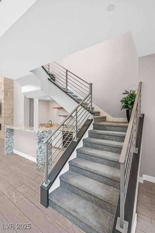 stairs featuring baseboards and wood finished floors