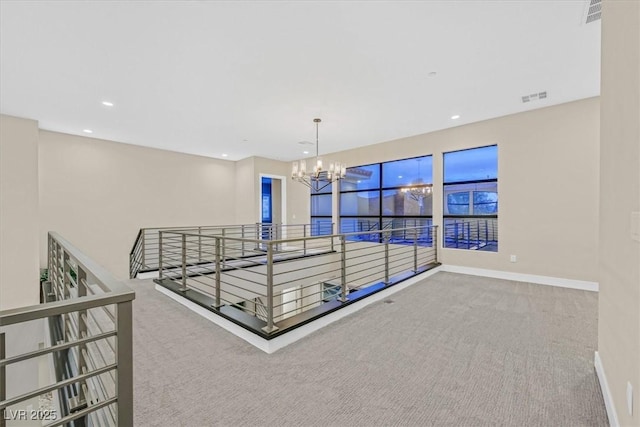 corridor with carpet floors, recessed lighting, visible vents, an inviting chandelier, and baseboards