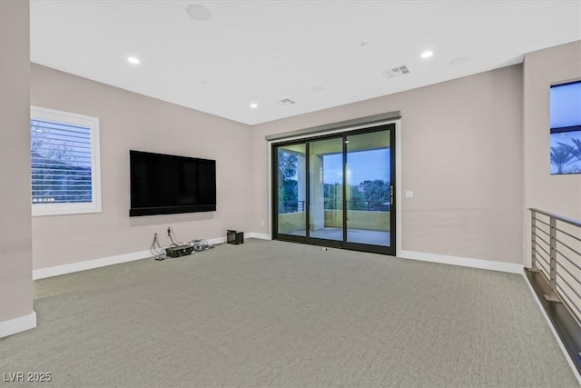 unfurnished living room featuring carpet floors and baseboards