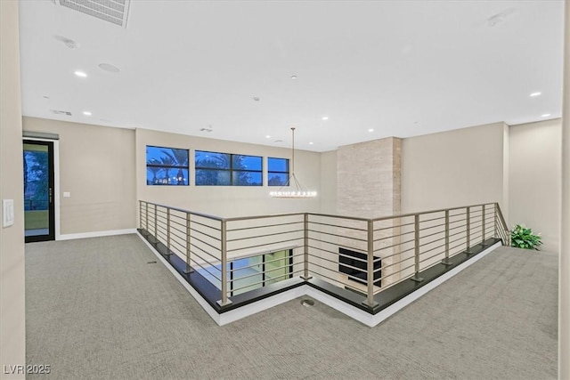 hallway with recessed lighting, carpet flooring, visible vents, and baseboards