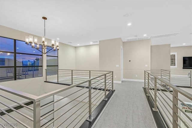 corridor featuring recessed lighting, carpet, an upstairs landing, and an inviting chandelier