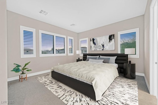 bedroom featuring carpet floors, baseboards, and visible vents