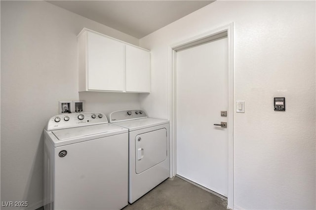 washroom featuring cabinets and washing machine and dryer