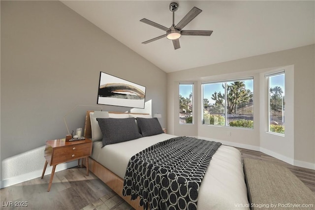 bedroom with ceiling fan, wood-type flooring, and vaulted ceiling