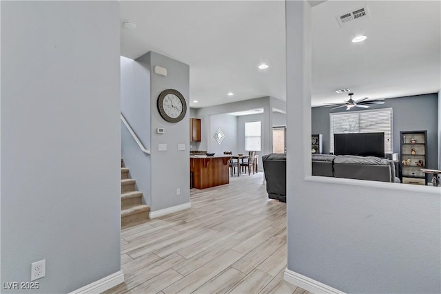 interior space with ceiling fan and light hardwood / wood-style flooring