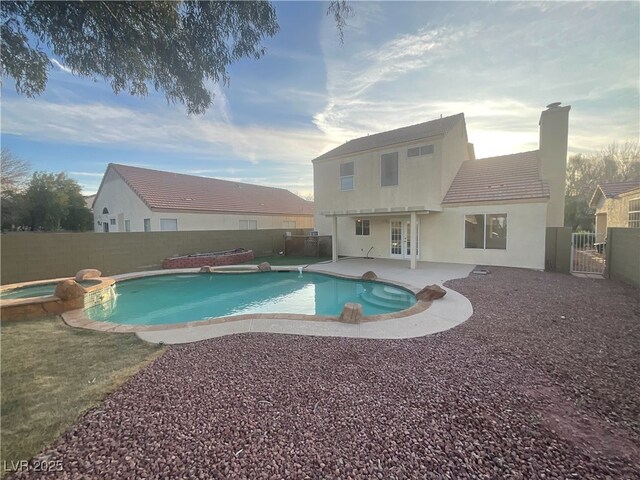 view of swimming pool with a fenced backyard, french doors, a patio, and a gate