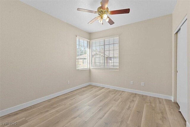 unfurnished bedroom featuring light hardwood / wood-style floors, a closet, and ceiling fan