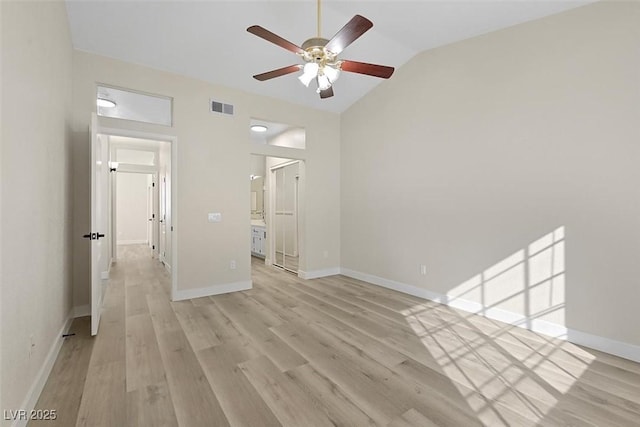 empty room featuring vaulted ceiling, ceiling fan, and light wood-type flooring