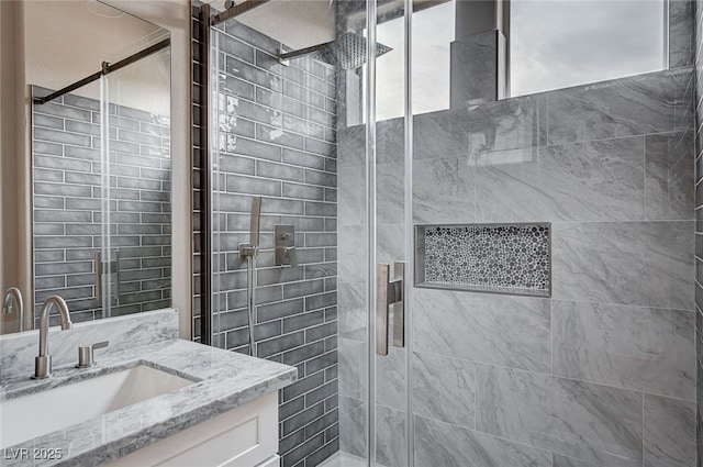 bathroom with vanity and a shower with door