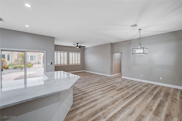 unfurnished living room with light hardwood / wood-style floors and ceiling fan