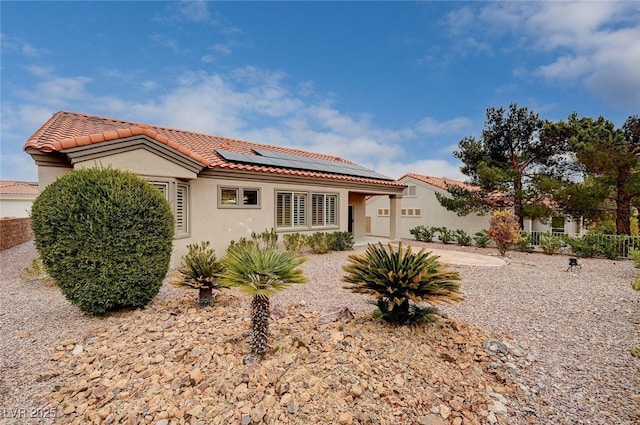 view of front of house featuring a patio and solar panels