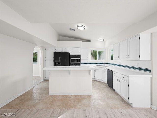 kitchen with sink, black appliances, white cabinets, and a kitchen island