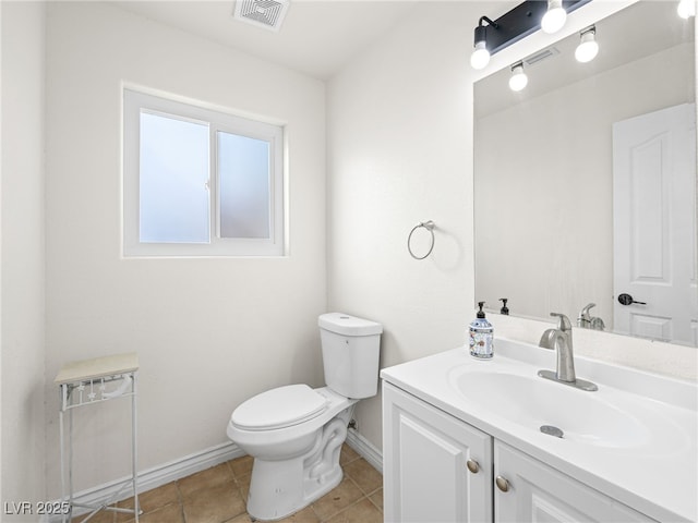 bathroom featuring tile patterned floors, vanity, and toilet