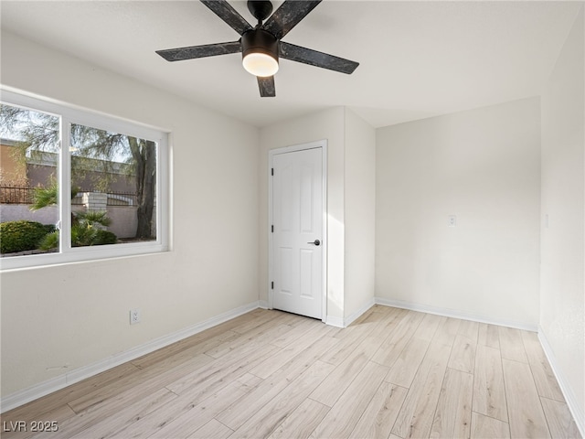 empty room with light hardwood / wood-style floors and ceiling fan