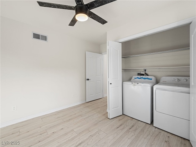 washroom with washer and clothes dryer, ceiling fan, and light wood-type flooring