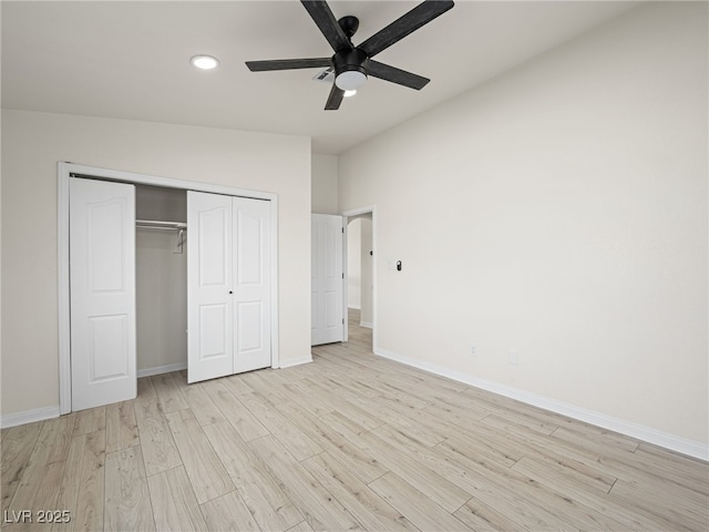 unfurnished bedroom featuring ceiling fan, light hardwood / wood-style floors, and a closet