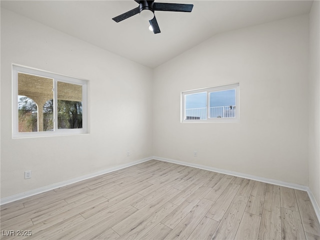 spare room with vaulted ceiling, ceiling fan, and light hardwood / wood-style floors